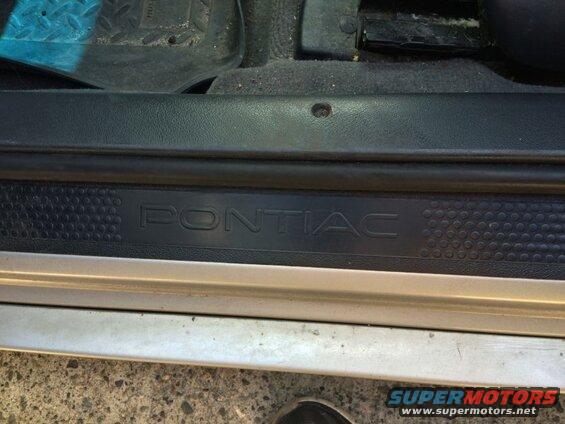 Close-up of the Pontiac Grand Prix door sill with the embossed logo.
