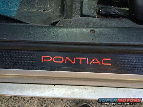 Pontiac Grand Prix door sill plate with red illuminated lettering.