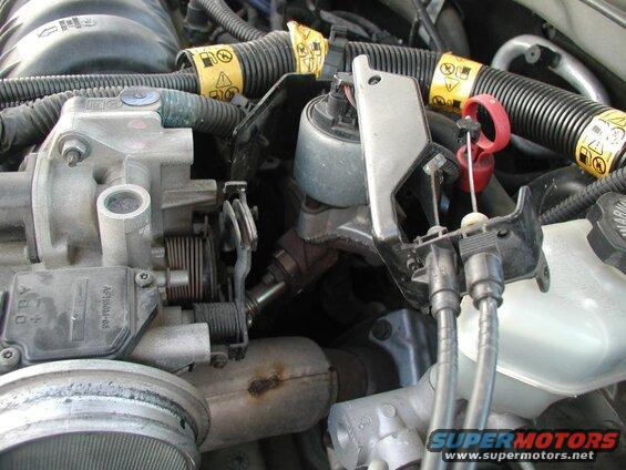 Remove the throttle cable bracket (2x 10 mm bolts) and disconnect the throttle and cruise control cables.