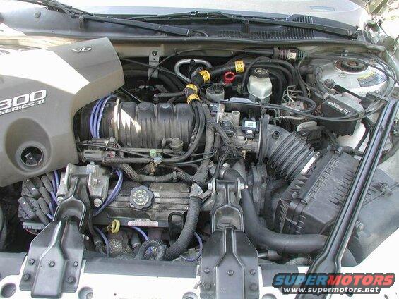 Remove the engine cover and air intake hose.