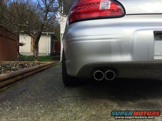Silver Pontiac Grand Prix rear driver's side view with dual exhaust pipes.