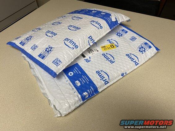 Two Amazon Prime padded envelopes stacked on a table.