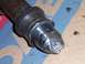 2000 Ford F-450 - Close-up view of a damaged metal part, possibly a shaft, showing signs of impact and wear.