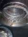 2000 Ford F-450 - This engine bearing shows significant damage and wear, indicating a potential mechanical failure.