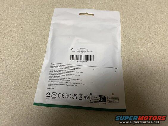White plastic bag with product information and logos.