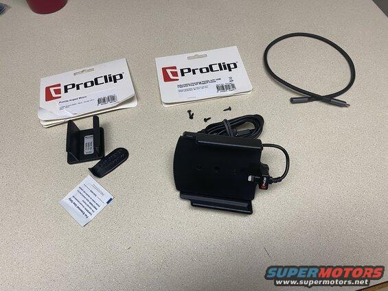 ProClip vehicle mounting accessories including brackets, a charging holder, and wipes on a countertop.