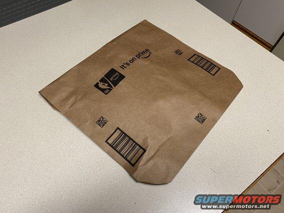 Brown Amazon Prime shipping envelope with NBA logo and barcodes.