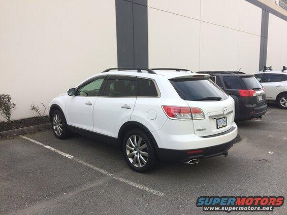 White 2009 Mazda CX-9 parked in a lot, rear passenger side view.