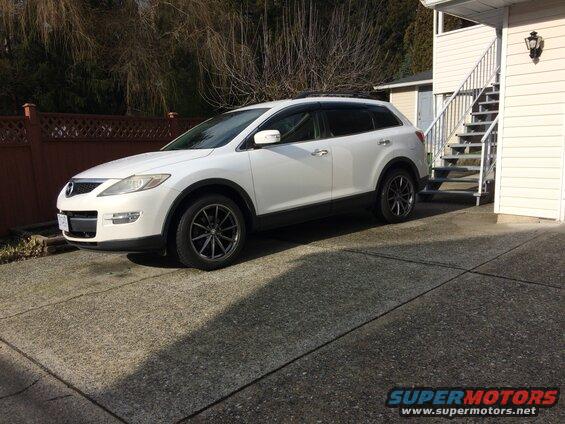 White 2009 Mazda CX-9 parked in driveway.