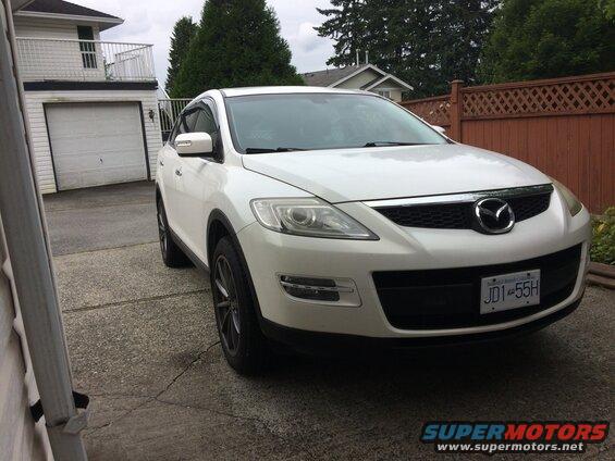 White 2009 Mazda CX-9 parked in a driveway.