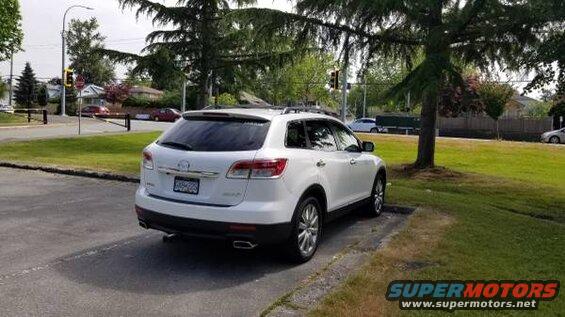 White 2009 Mazda CX-9 parked on asphalt, rear 3/4 view.