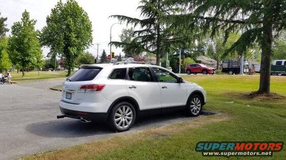 White 2009 Mazda CX-9 parked on the side of the road.