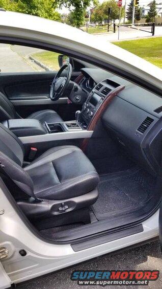 Interior of a white 2009 Mazda CX-9 showing dashboard, steering wheel, center console, and front seats.