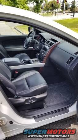 Interior view of a 2009 Mazda CX-9, showing dashboard, steering wheel, and seats.