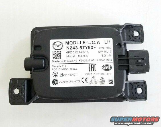 Black Mazda radar module with labels and mounting brackets.