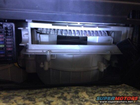 Dirty cabin air filter in white housing