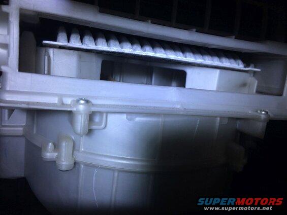 Dirty cabin air filter in white plastic housing