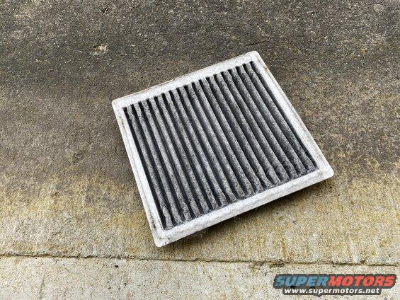 Dirty cabin air filter on concrete