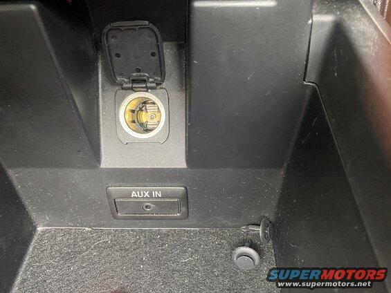 Car interior center console with 12V outlet and AUX IN port
