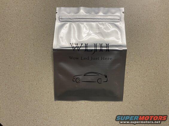 Silver resealable bag with black text and car silhouette on a countertop.