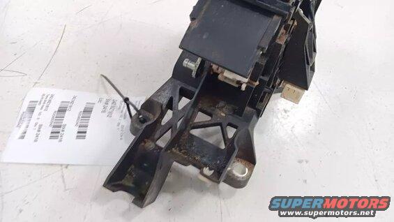 Black plastic automotive part with a white label attached.