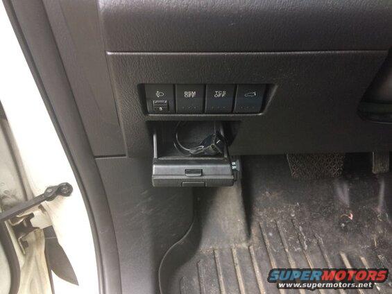 2009 Mazda CX-9 driver's side dashboard with various buttons and a storage compartment.
