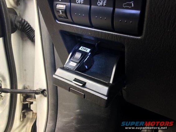 Close-up of a DRL switch in the 'OFF' position on a car dashboard.