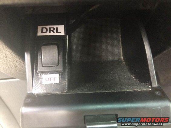 DRL switch labeled 'OFF' inside a vehicle.
