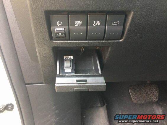 Close-up of dashboard buttons and a pedal in a 2009 Mazda CX-9.