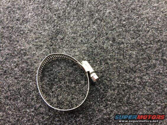 Metal hose clamp on a dark gray textured surface