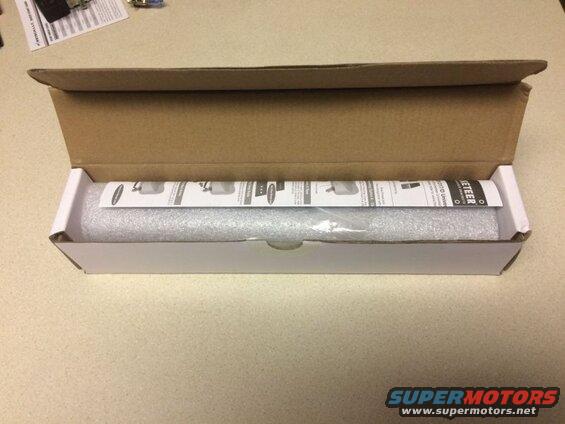 Opened box with bubble-wrapped item and instructions.