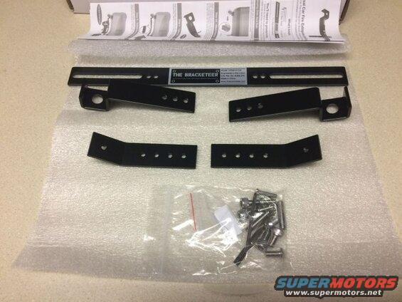Black metal mounting brackets and hardware for a fire extinguisher.