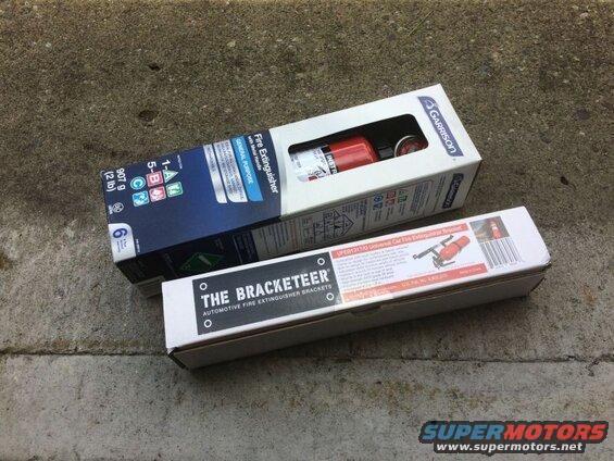 Boxes for a Garrison fire extinguisher and a Bracketeeer fire extinguisher bracket on concrete.