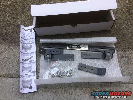 Fire extinguisher mounting bracket kit with instructions and hardware.