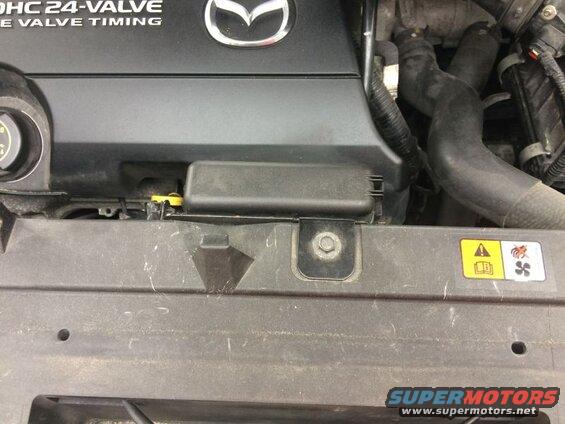 Close-up of Mazda CX-9 engine bay, showing engine cover and radiator support.