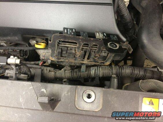 Engine bay of a 2009 Mazda CX-9 showing ignition coil pack and wiring.