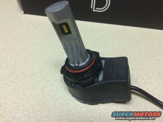Aftermarket LED headlight bulb with black base and silver heat sink.