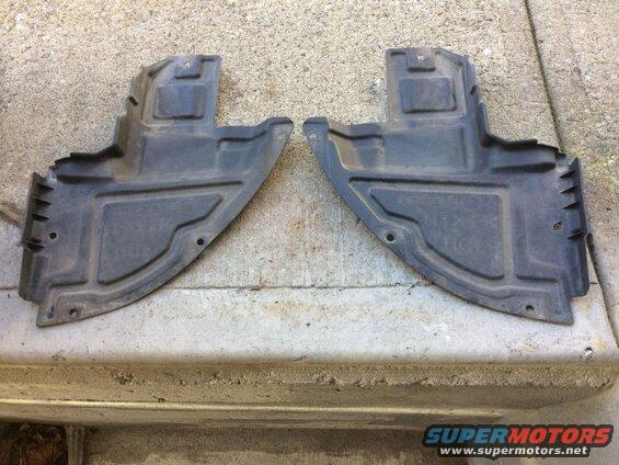 Two black plastic underbody splash shields