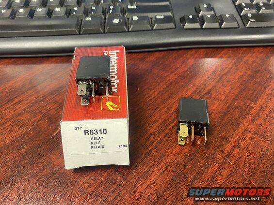 Black Intermotor R6310 relay and packaging on a wooden desk.