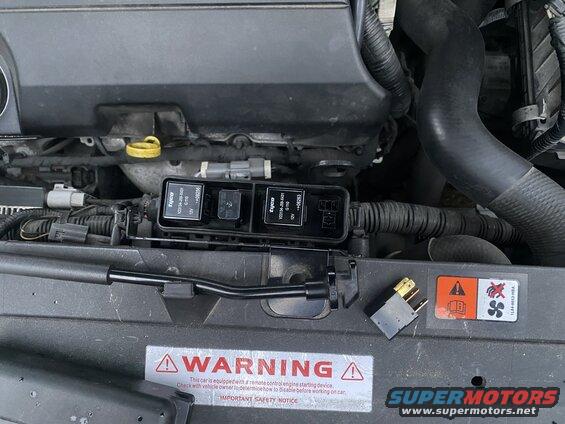 2009 Mazda CX-9 engine bay with fuse box and detached relay.