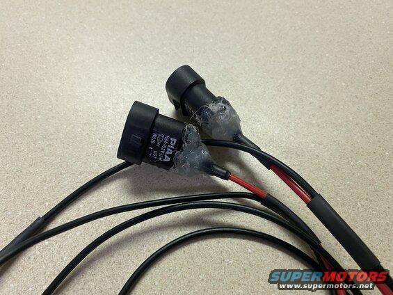 Two PIAA H4-H11-12V-51W electrical connectors with wires.