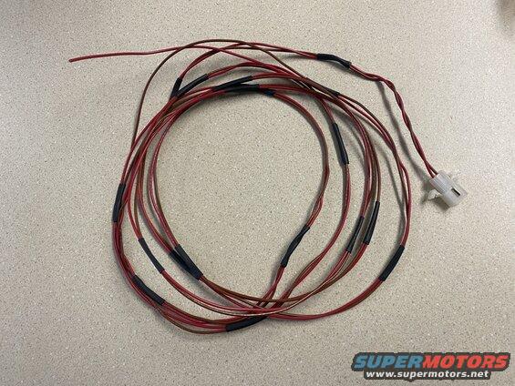 Bundle of red and brown wires with a white connector on a countertop
