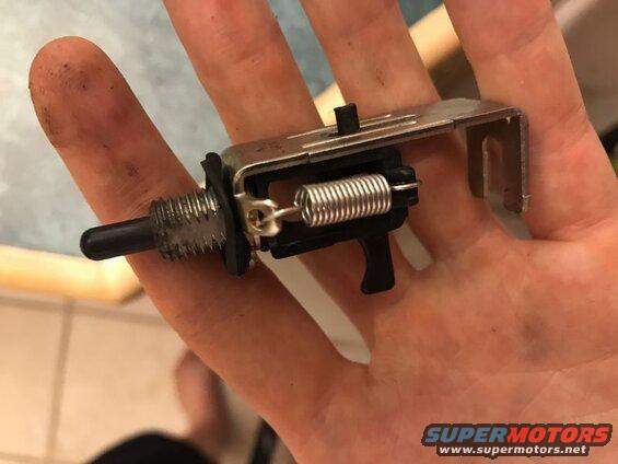 Mechanical switch part with spring held in hand