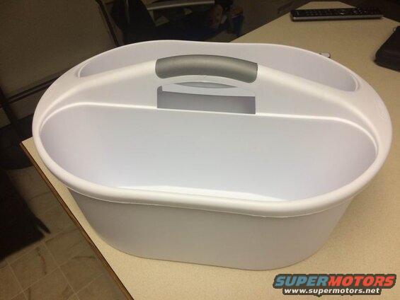 White plastic caddy with gray handle on a desk
