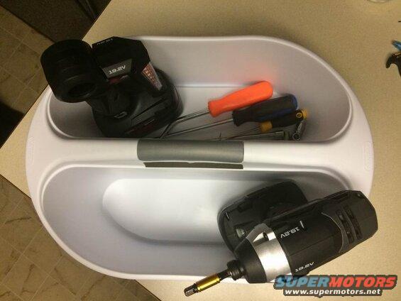 White toolbox with two drills and screwdrivers inside.