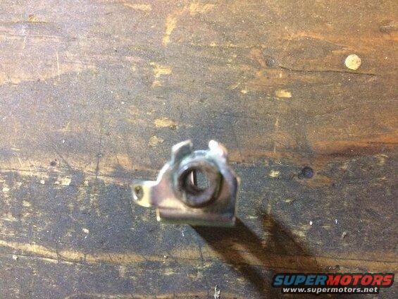 Pry the two ears enough to loosen the nut so it can slide out.