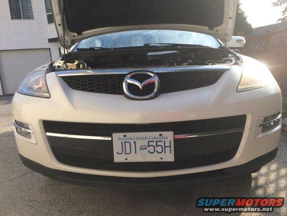 White 2009 Mazda CX-9 front view, hood open, license plate JD1 55H