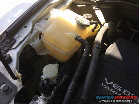 Right side: remove the 3 10mm bolts and move the coolant overflow tank out of the way.
