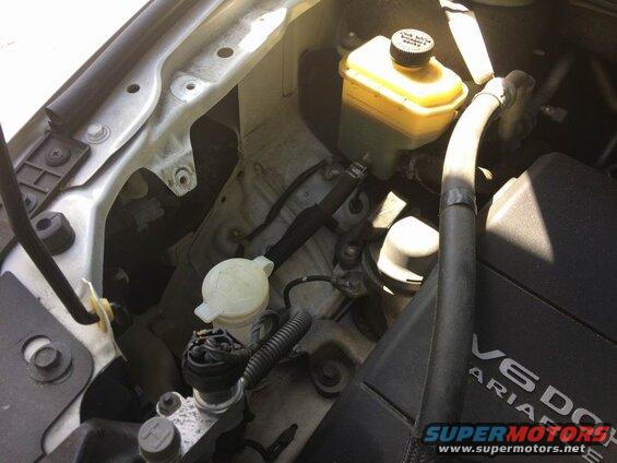 Right side: remove the 3 10mm bolts and move the coolant overflow tank out of the way.