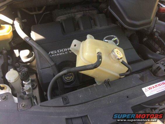 Right side: remove the 3 10mm bolts and move the coolant overflow tank out of the way.